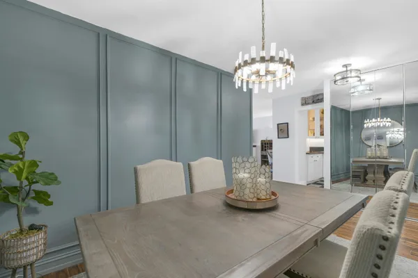 a view of a dining room with furniture and chandelier