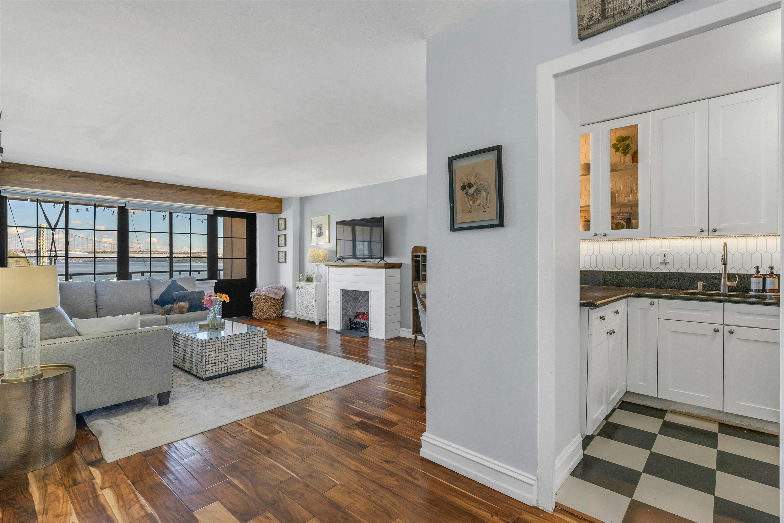 1203 River Road, Unit 9D Edgewater, NJ 07020 - Photo 6 of 28 a living room with furniture and wooden floor
