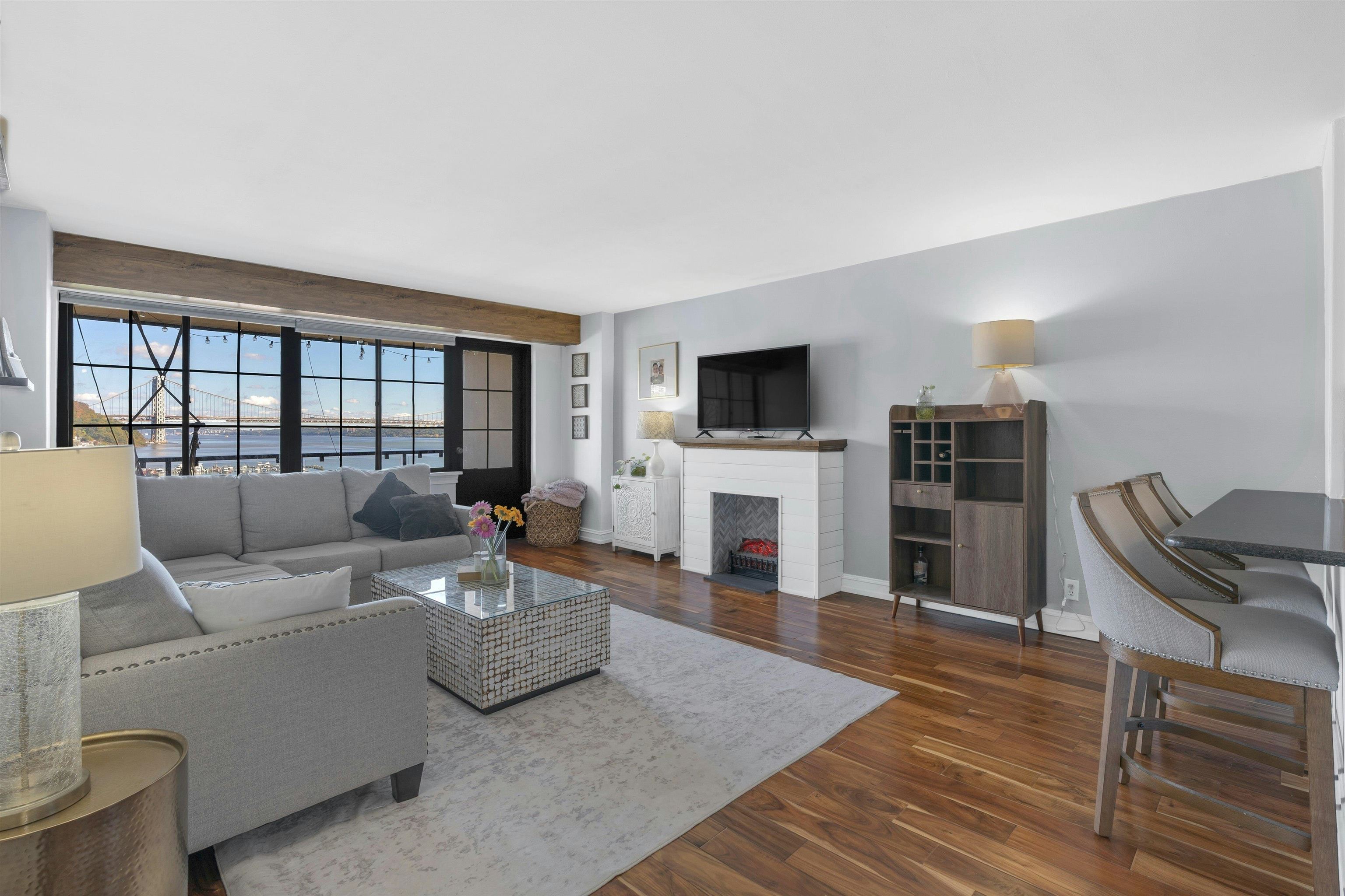 1203 River Road, Unit 9D Edgewater, NJ 07020 - Photo 7 of 28 a living room with furniture and a fireplace