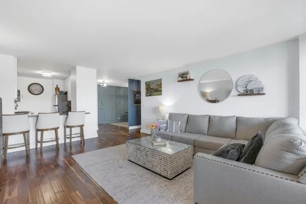 a living room with furniture and wooden floor