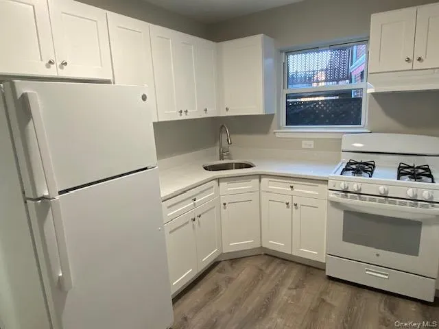 a kitchen with cabinets appliances and a sink