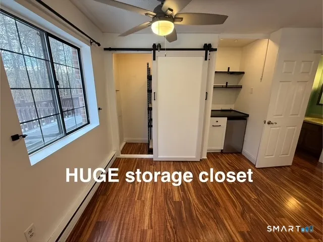 a view of a hallway with wooden floor