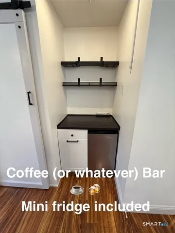 a view of a room with wooden floor