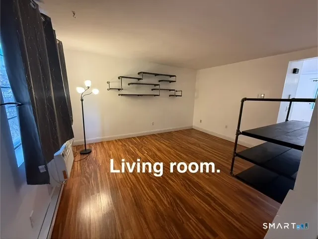 a view of a hall with wooden floor