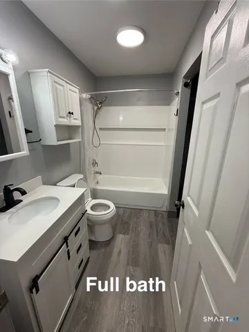 a view of an entryway with wooden floor