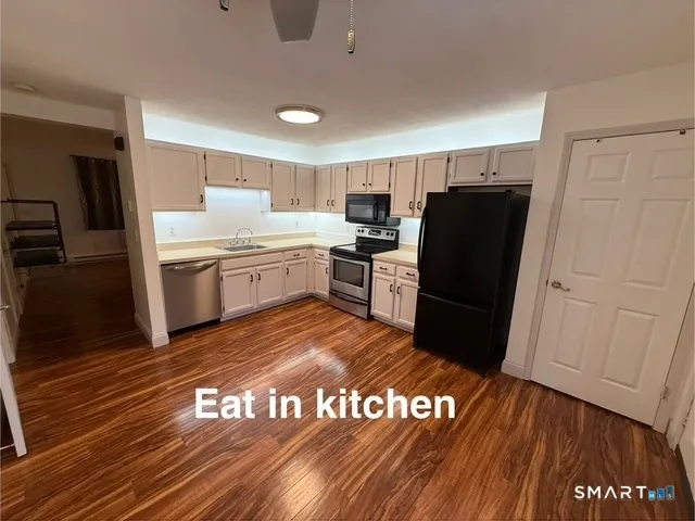 a kitchen with a refrigerator and a stove