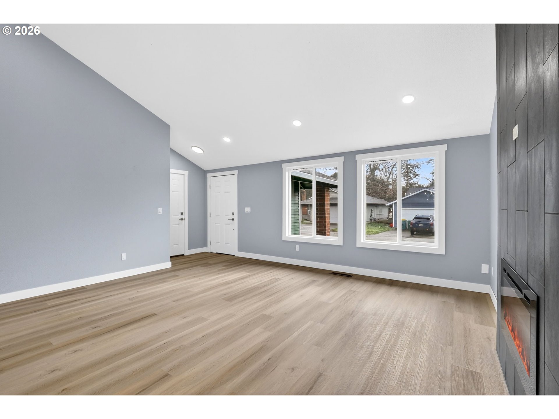 18830 Southwest Butternut Street Beaverton, OR 97078 - Photo 11 of 33 a view of an empty room with wooden floor and windows