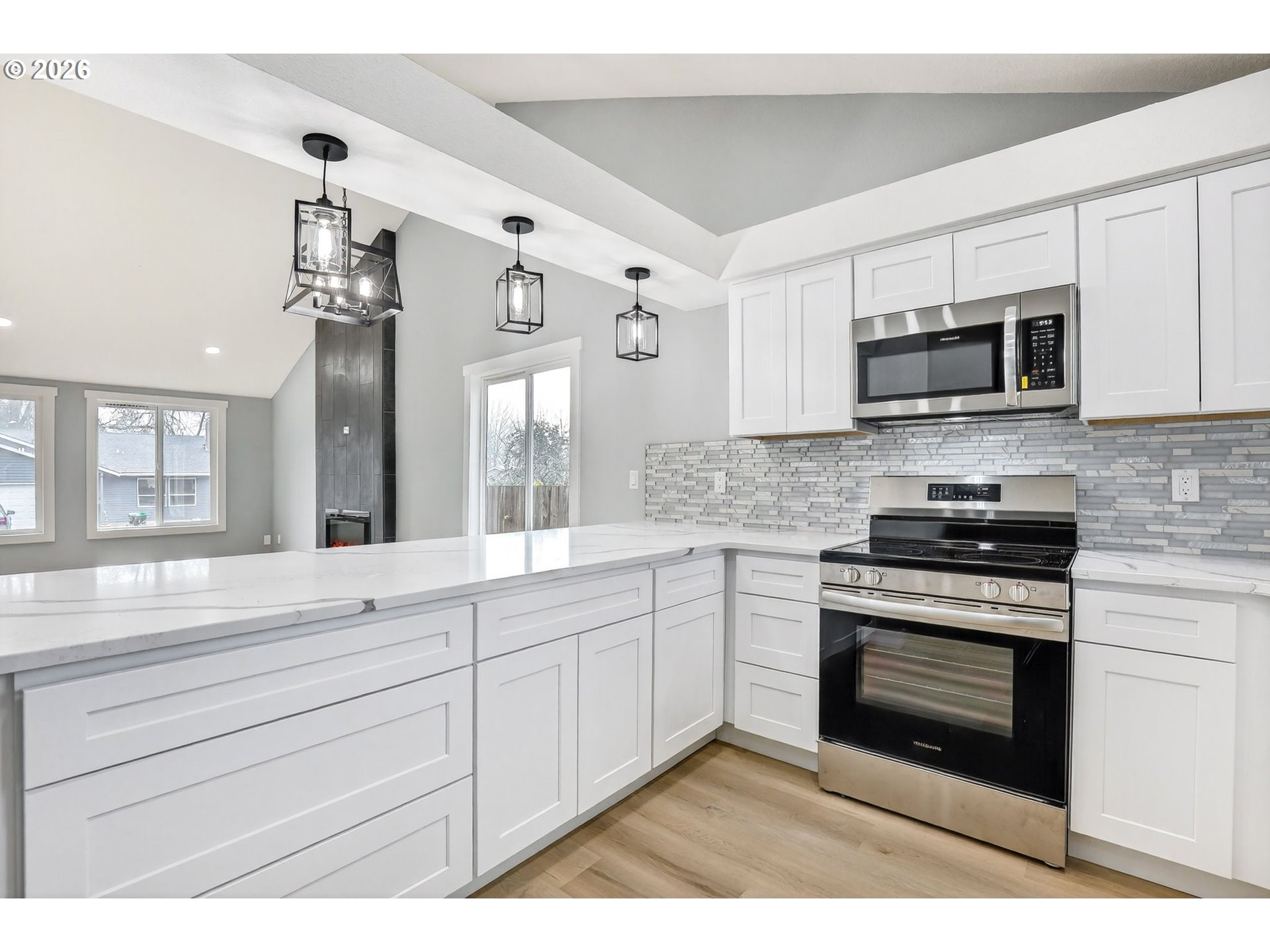 18830 Southwest Butternut Street Beaverton, OR 97078 - Photo 17 of 33 a kitchen with stainless steel appliances granite countertop a stove and cabinets
