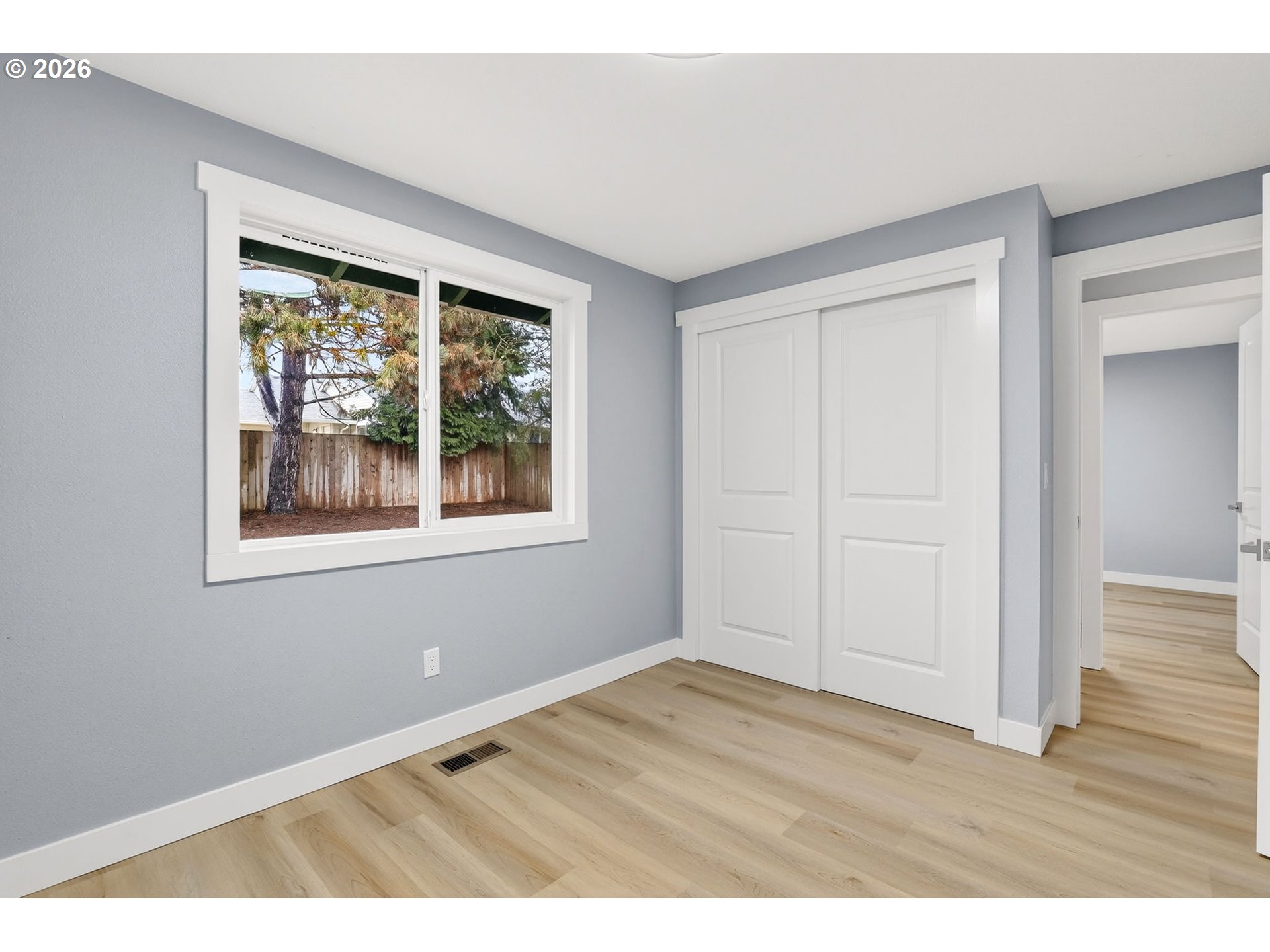 18830 Southwest Butternut Street Beaverton, OR 97078 - Photo 20 of 33 a view of an empty room with wooden floor and a window