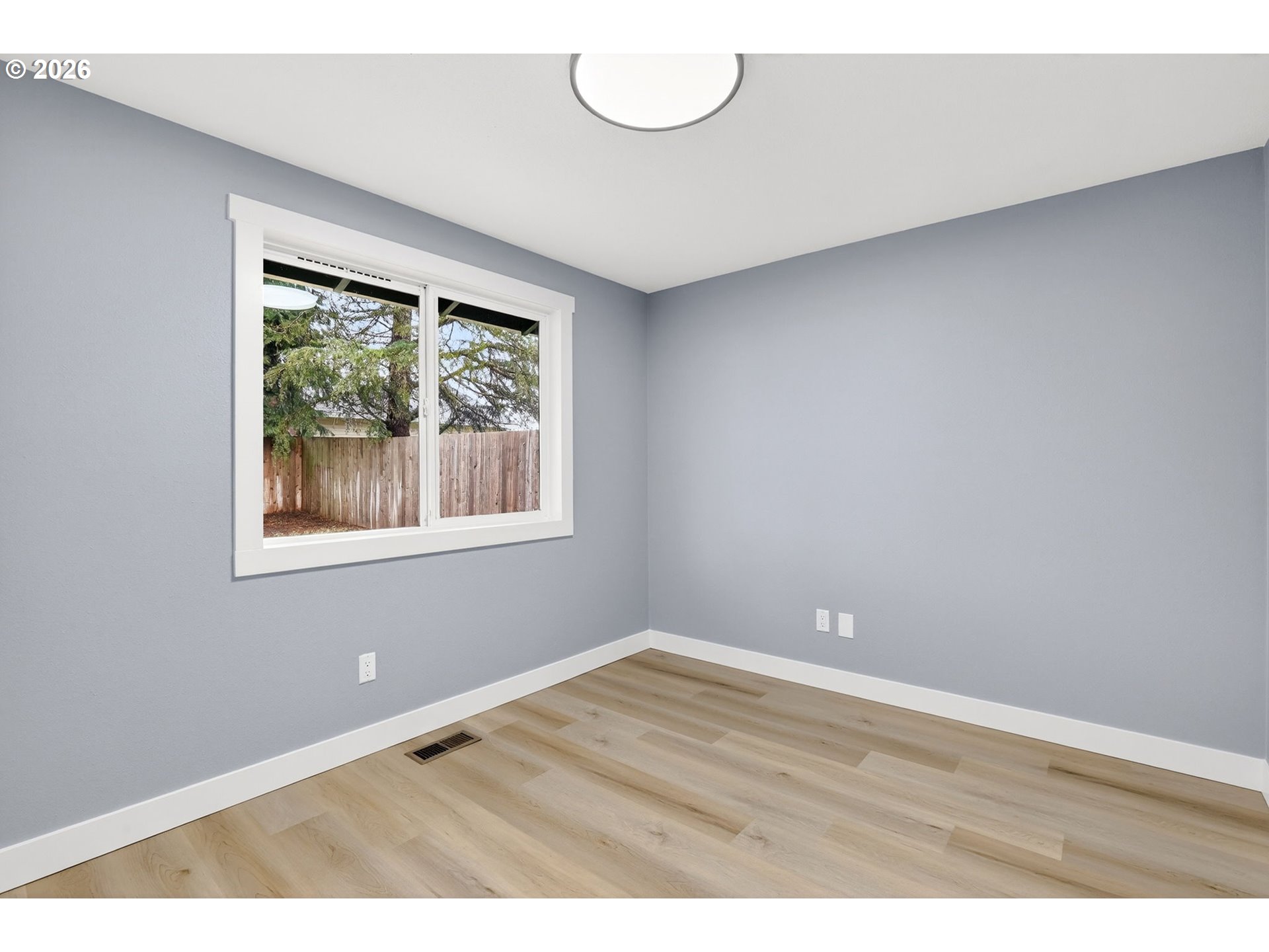 18830 Southwest Butternut Street Beaverton, OR 97078 - Photo 22 of 33 an empty room with wooden floor and windows