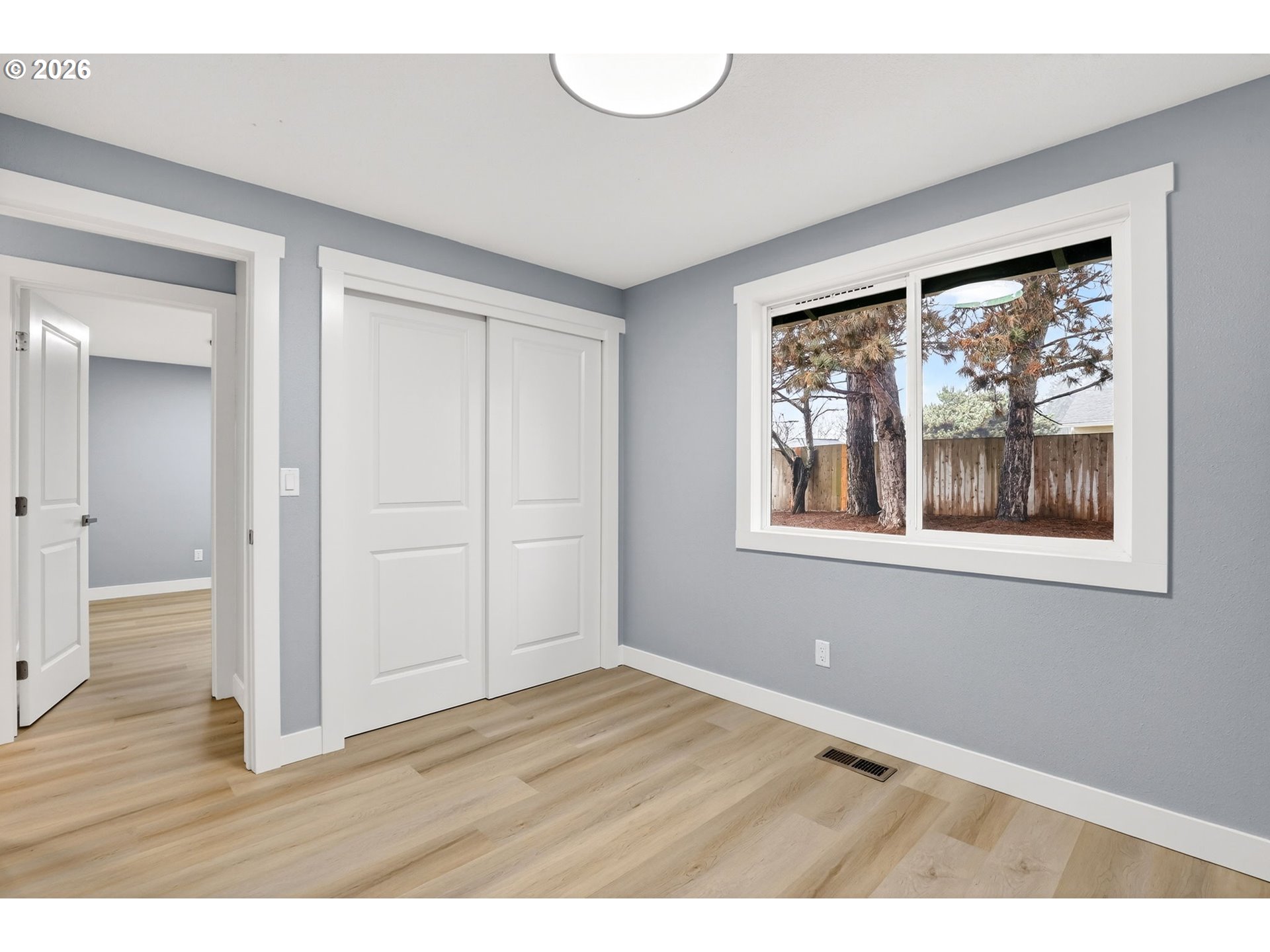 18830 Southwest Butternut Street Beaverton, OR 97078 - Photo 23 of 33 a view of an empty room with wooden floor and a window