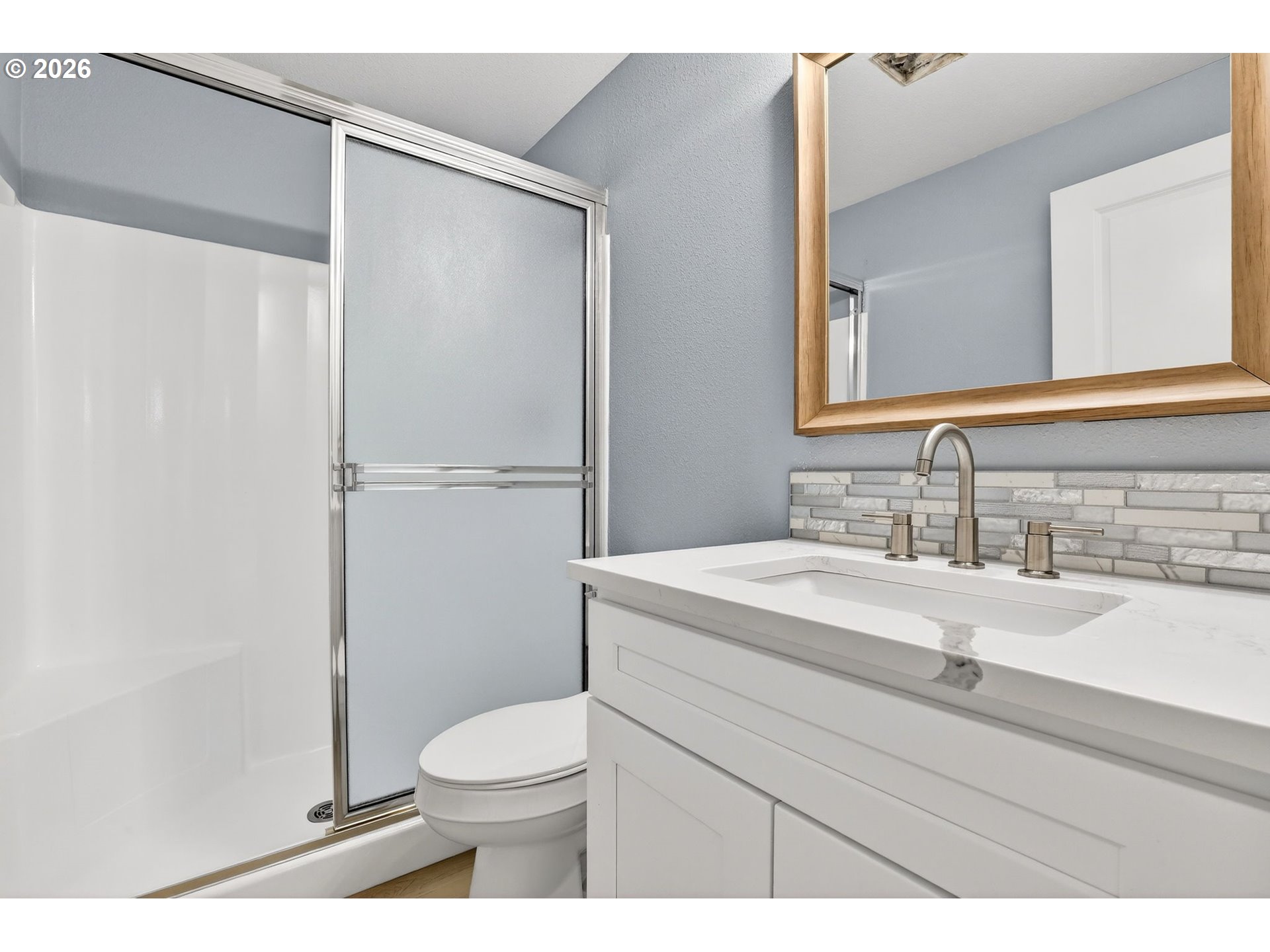 18830 Southwest Butternut Street Beaverton, OR 97078 - Photo 26 of 33 a bathroom with a sink a toilet a mirror and shower