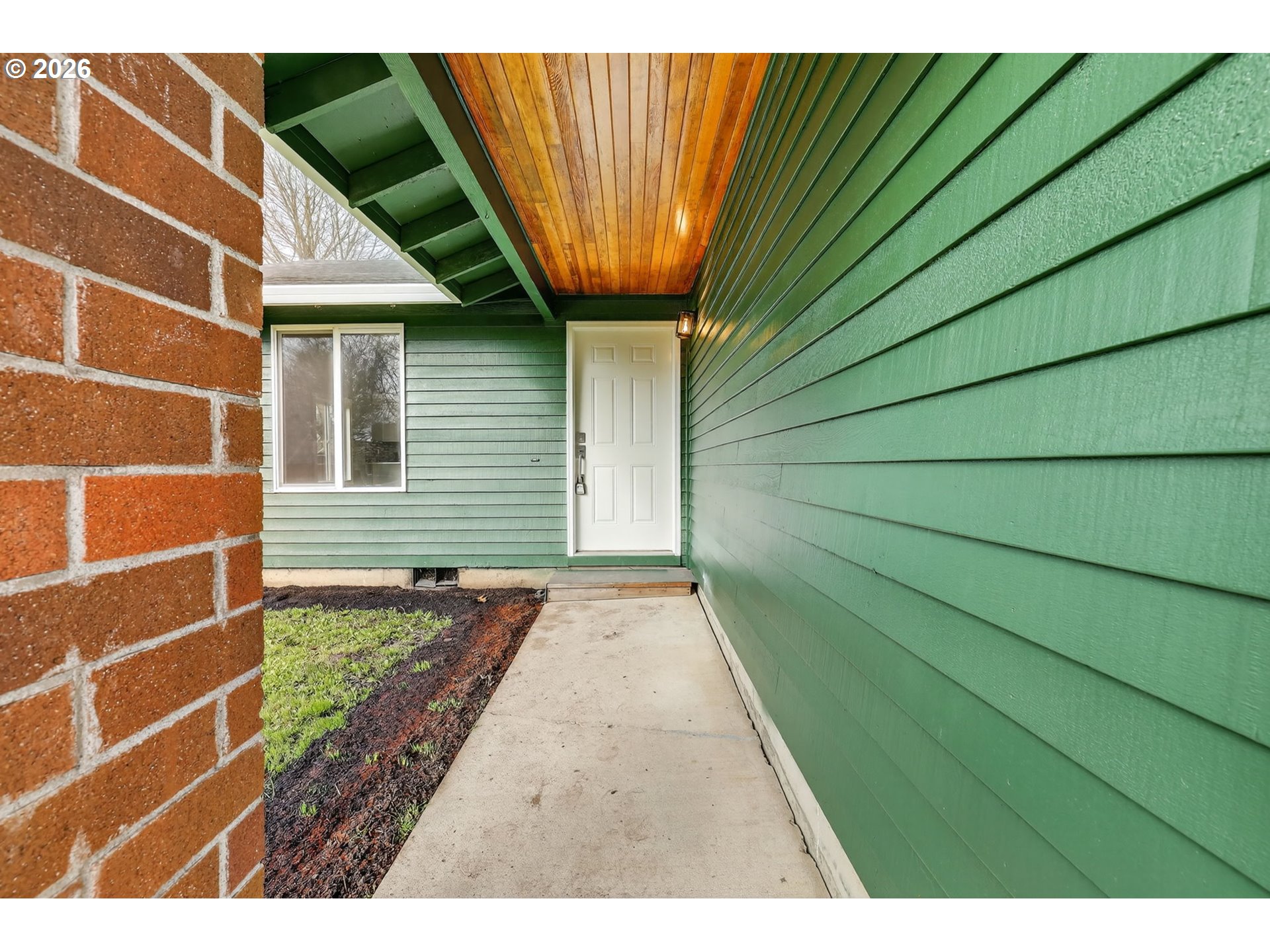 18830 Southwest Butternut Street Beaverton, OR 97078 - Photo 7 of 33 a view of a backyard with a door and wooden floor
