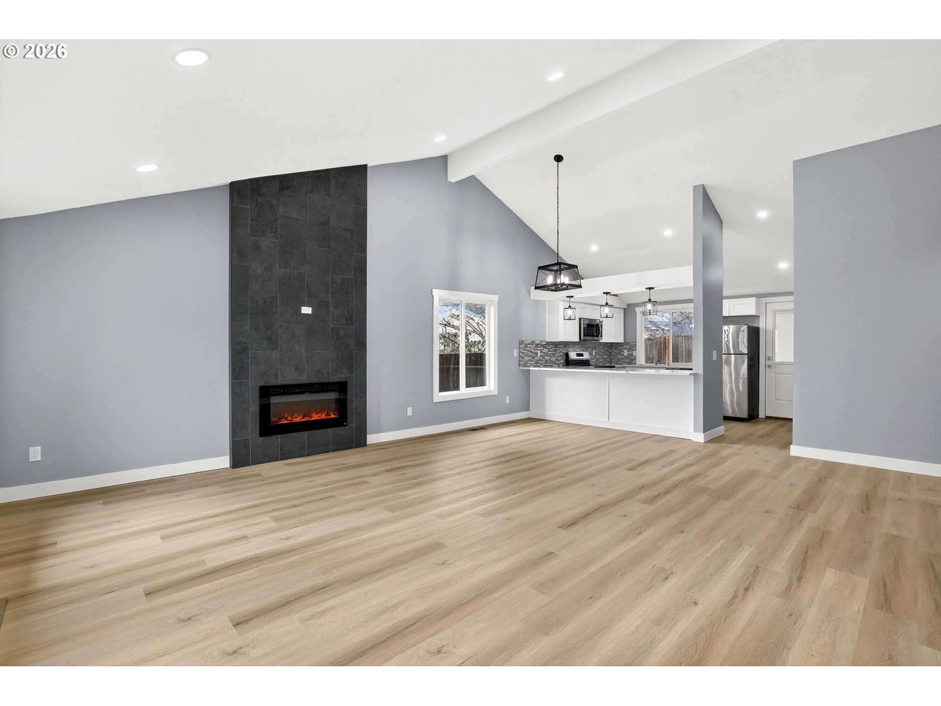 18830 Southwest Butternut Street Beaverton, OR 97078 - Photo 8 of 33 a view of an empty room with kitchen and window
