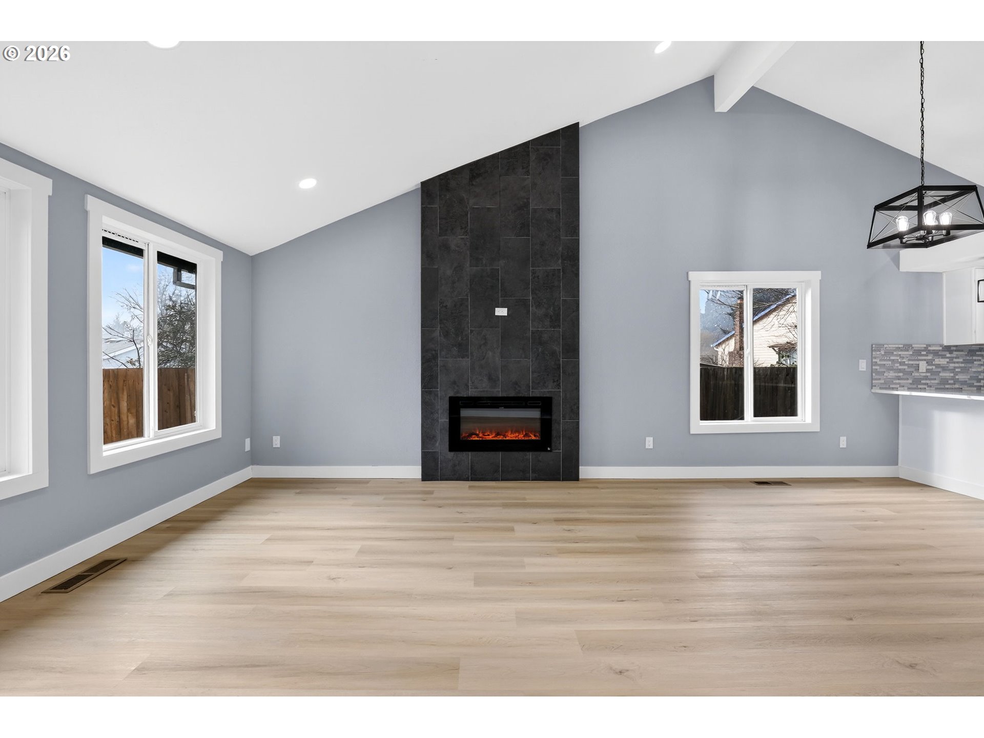 18830 Southwest Butternut Street Beaverton, OR 97078 - Photo 9 of 33 a view of an empty room with a window and wooden floor