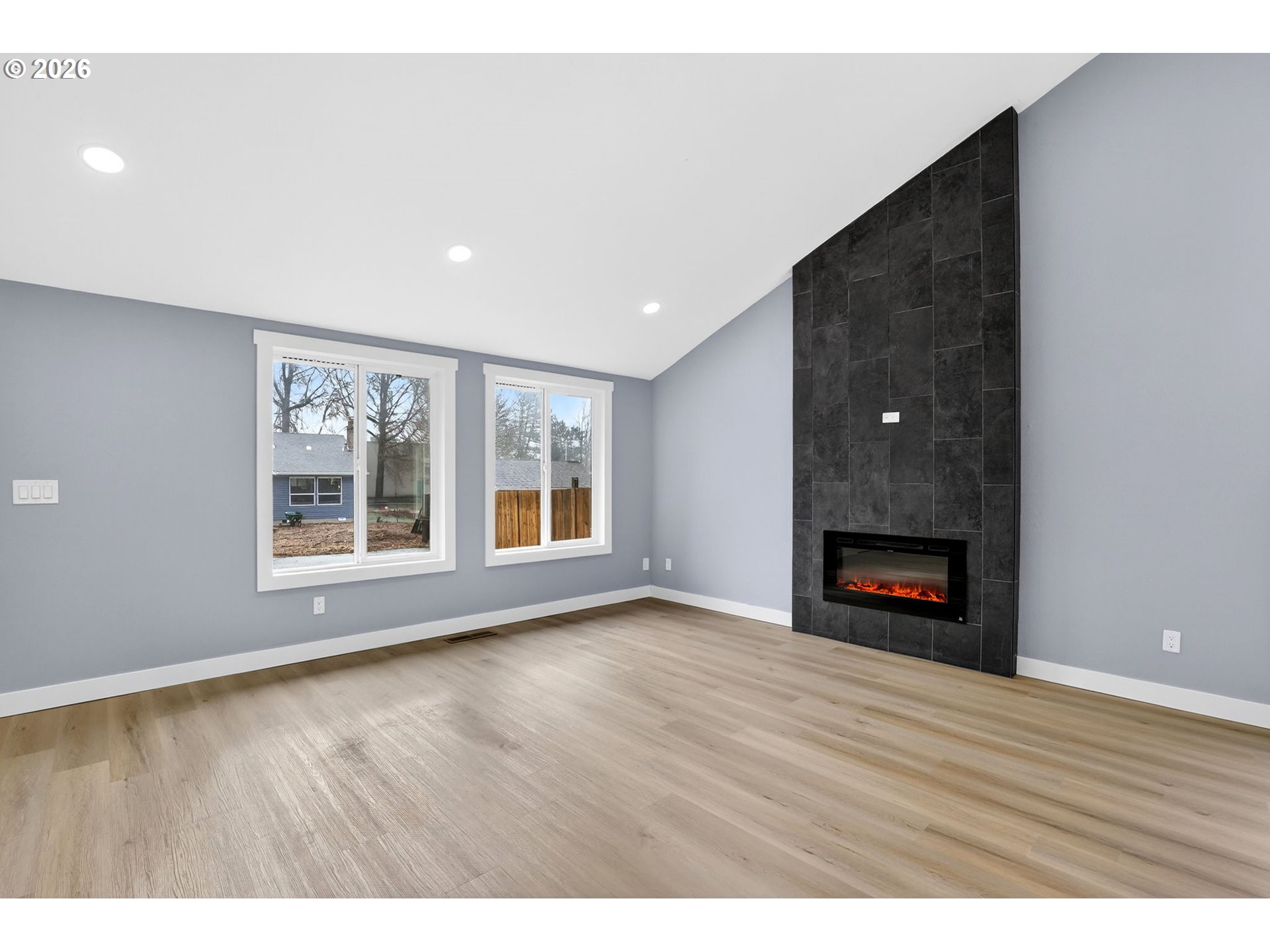 18830 Southwest Butternut Street Beaverton, OR 97078 - Photo 10 of 33 a view of an empty room with a window and wooden floor