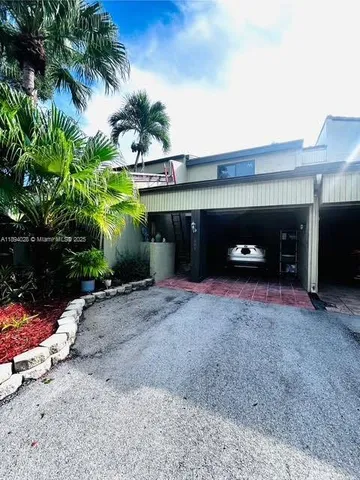 a front view of a house with a yard and a garage