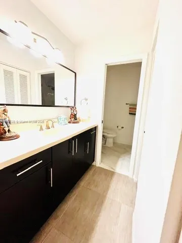 a spacious bathroom with a sink vanity and mirror