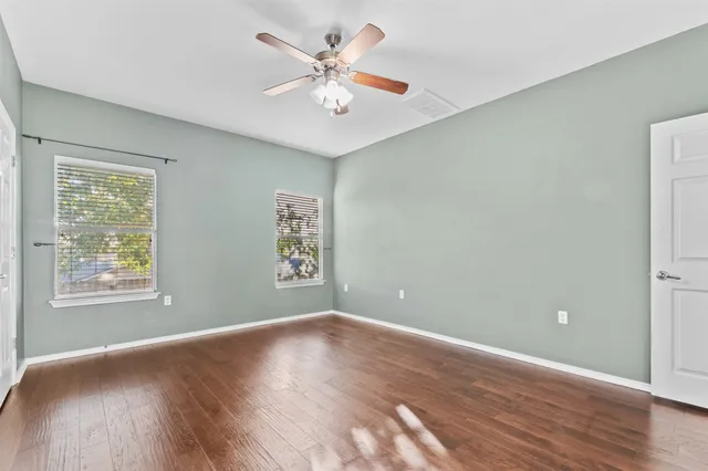 wooden floor in an empty room with a window