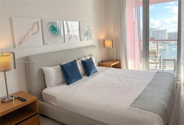 a bedroom with bed and a flat screen tv