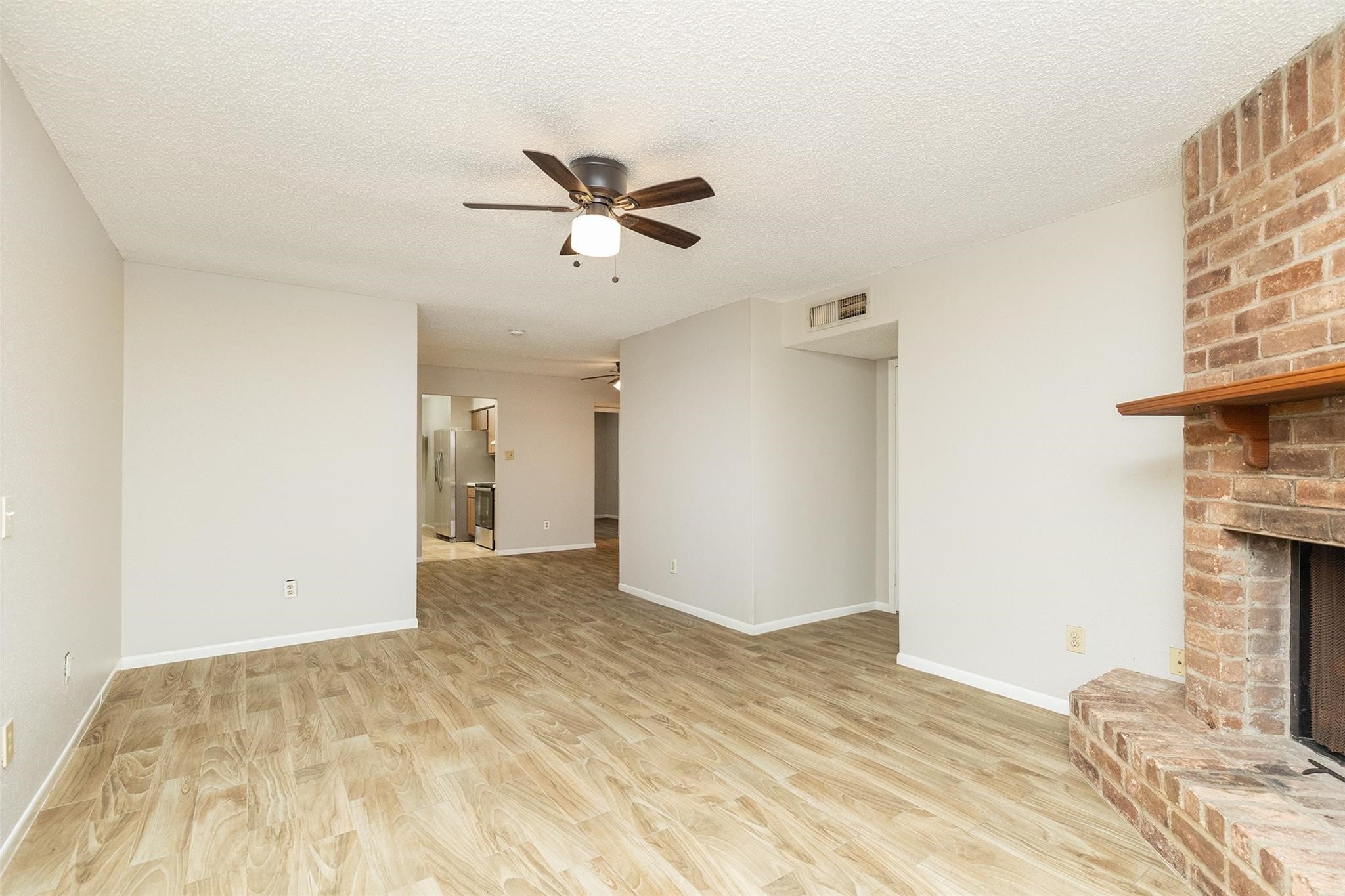 2800 Jeanetta Street, Unit 2805 Houston, TX 77063 - Photo 4 of 19 a view of empty room with a fireplace and fan