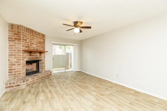 a view of empty room with fireplace