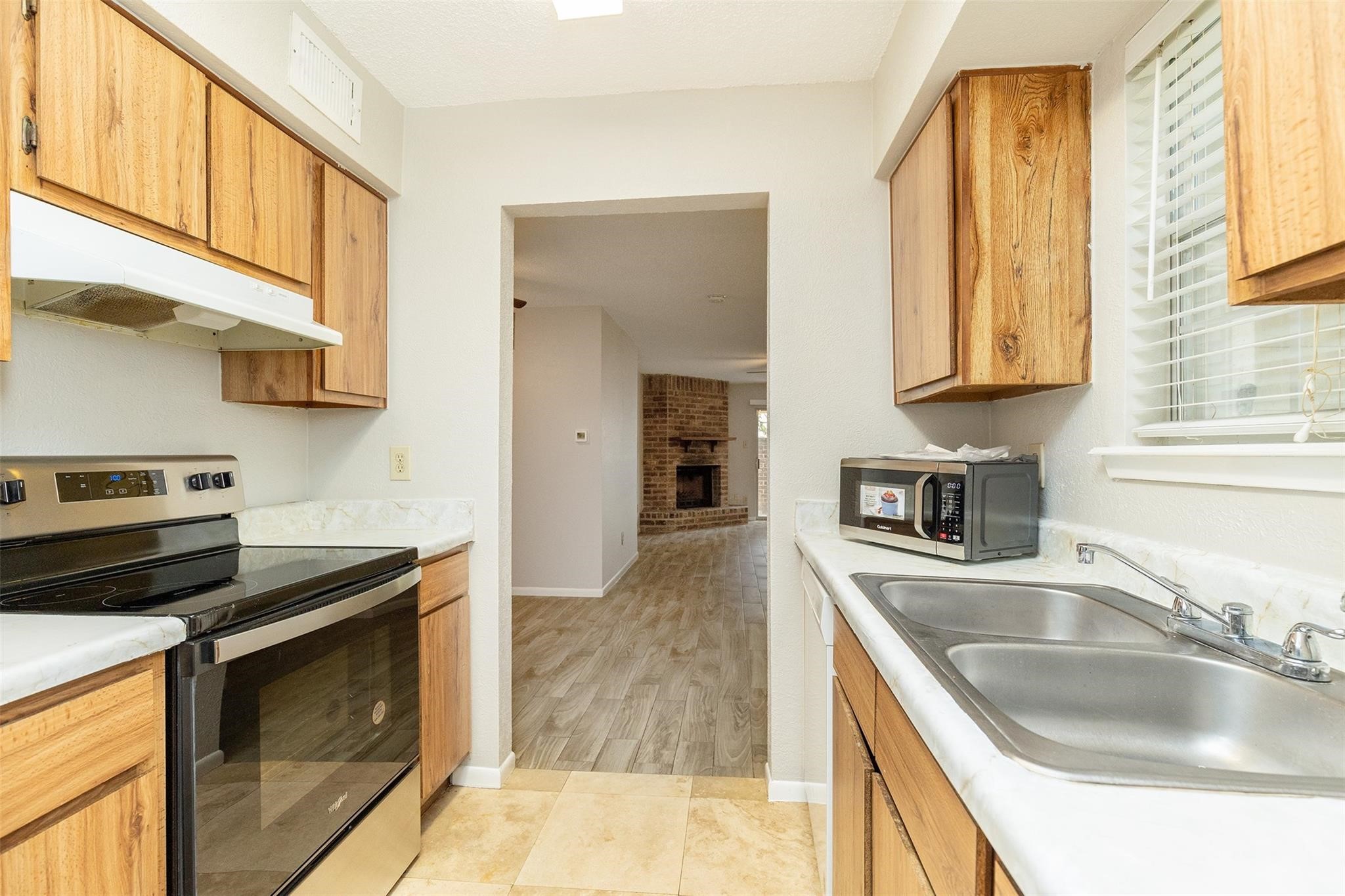 2800 Jeanetta Street, Unit 2805 Houston, TX 77063 - Photo 6 of 19 a kitchen with granite countertop a sink a stove and cabinets