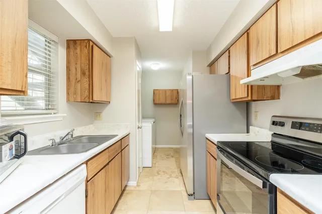 a kitchen that has a sink and a stove