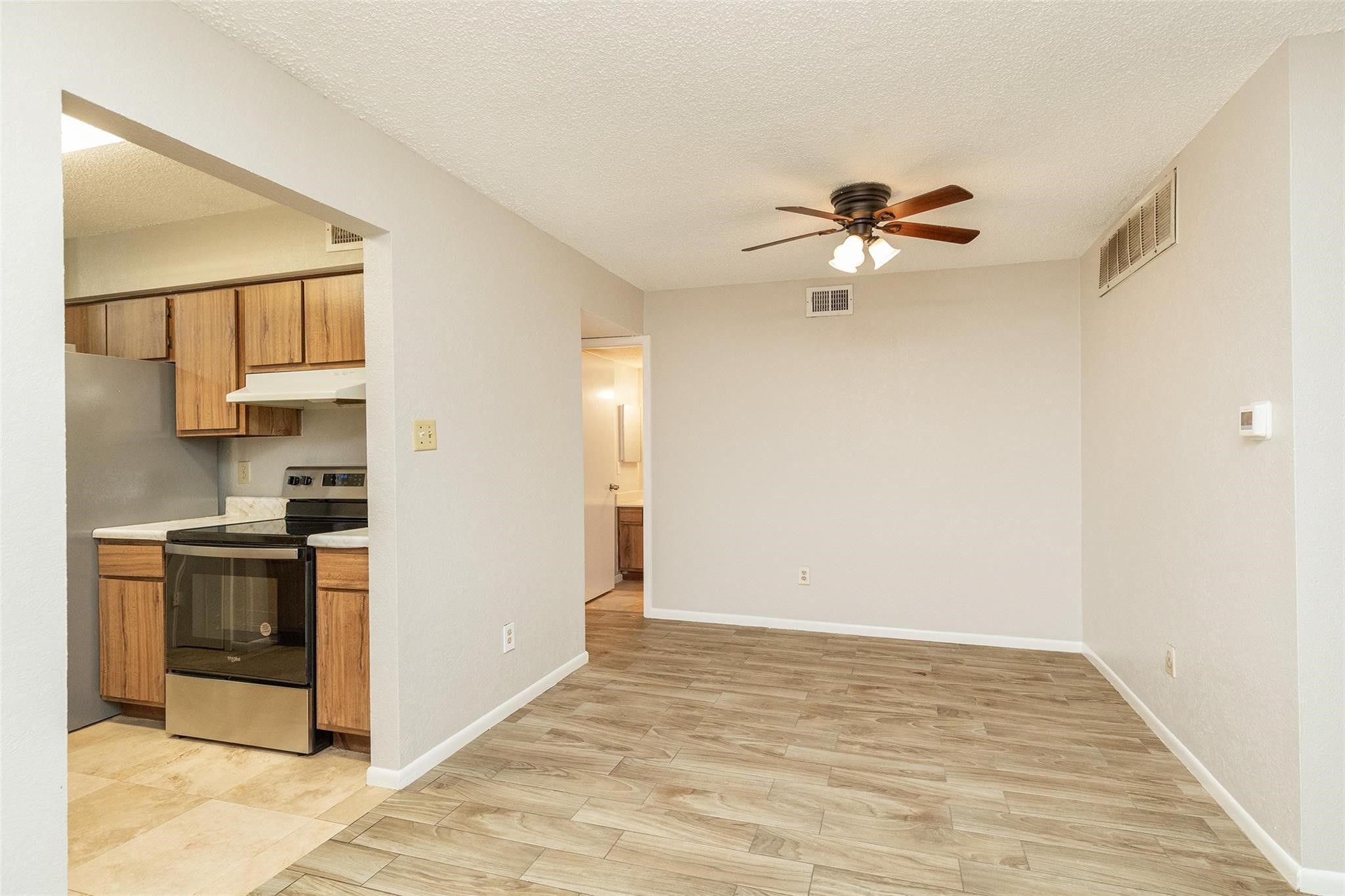 2800 Jeanetta Street, Unit 2805 Houston, TX 77063 - Photo 9 of 19 a view of a kitchen with a stove cabinets and a ceiling fan