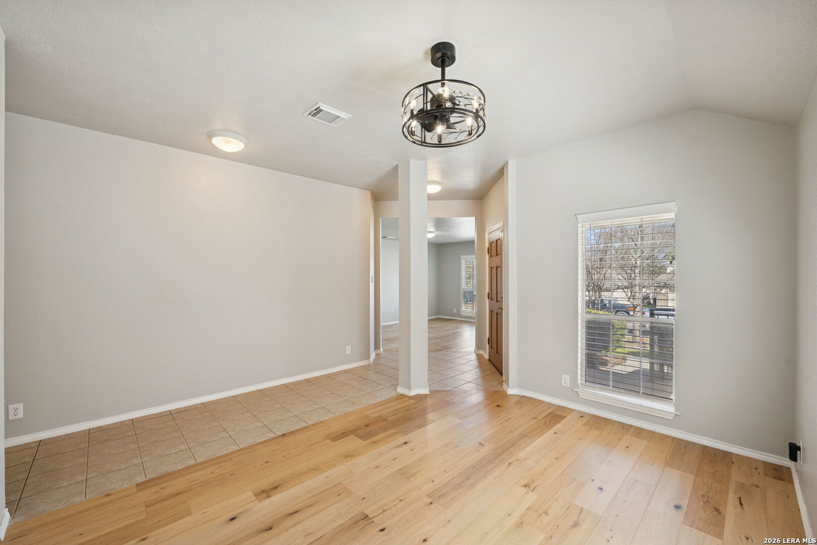 626 Rexton Lane San Antonio, TX 78258 - Photo 11 of 34 a view of an empty room with a window and wooden floor