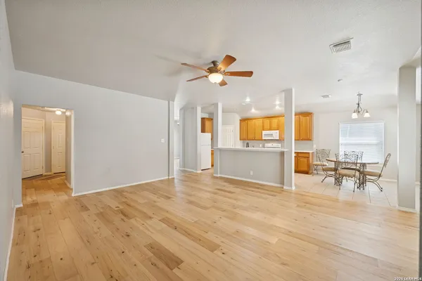 a living room with kitchen island furniture and a chandelier