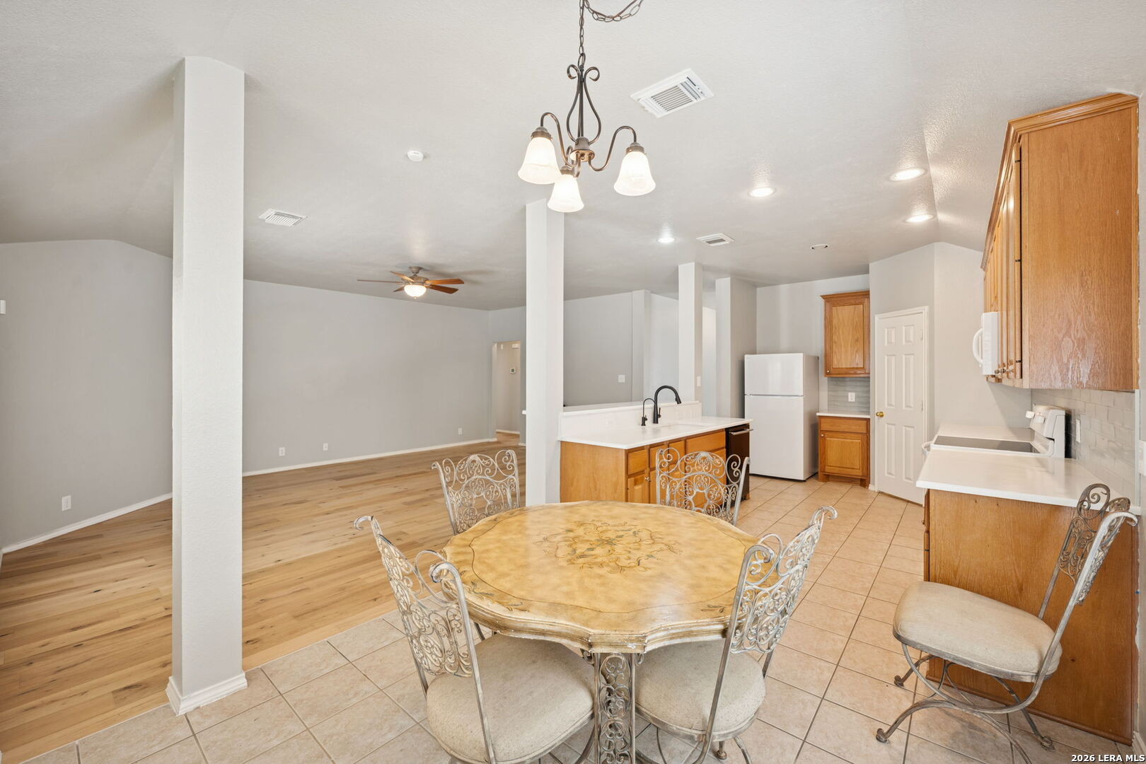 626 Rexton Lane San Antonio, TX 78258 - Photo 17 of 34 a living room with kitchen island furniture and a chandelier