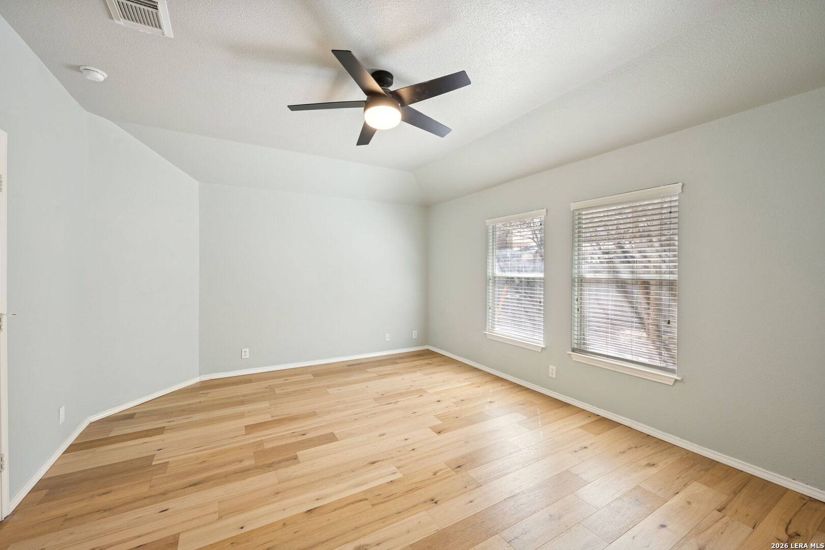 626 Rexton Lane San Antonio, TX 78258 - Photo 21 of 34 an empty room with wooden floor fan and windows