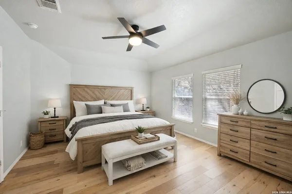an empty room with a window and a fan