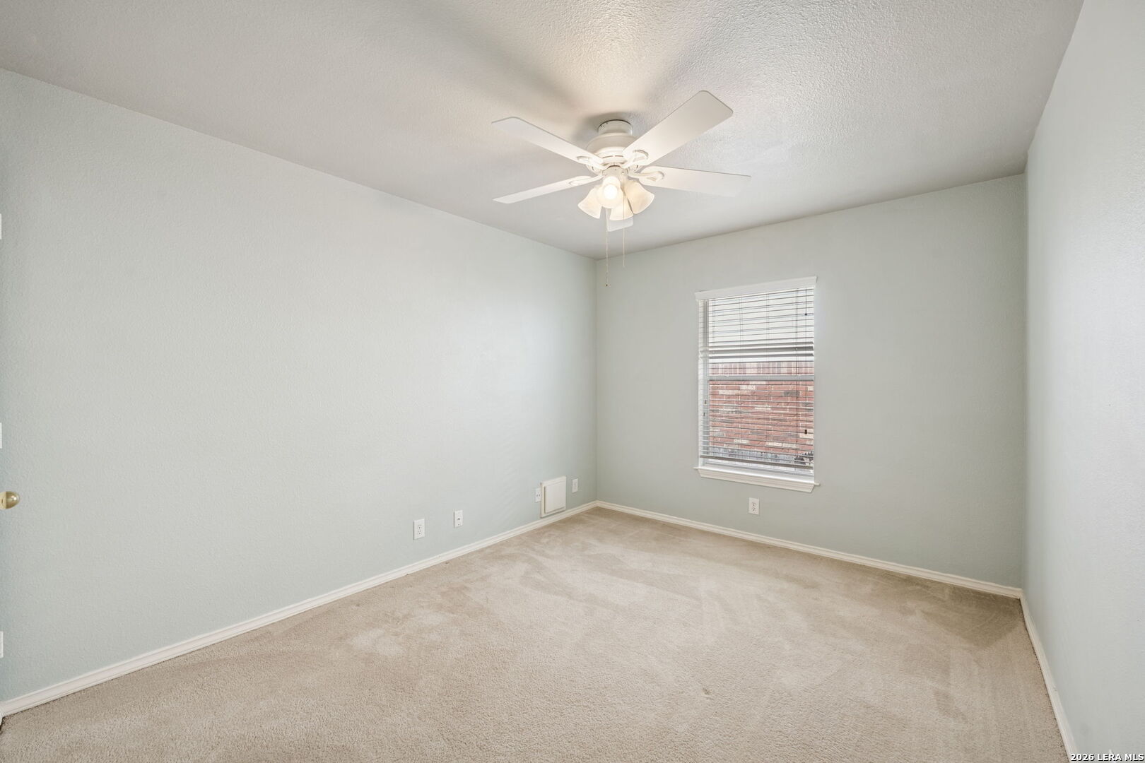 626 Rexton Lane San Antonio, TX 78258 - Photo 24 of 34 an empty room with a window and a fan