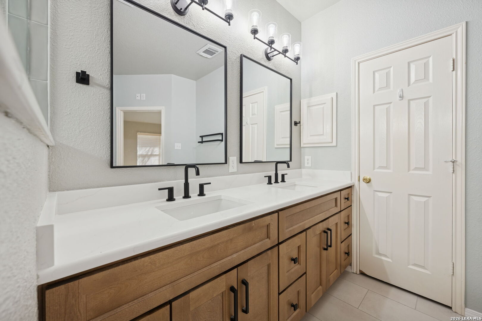 626 Rexton Lane San Antonio, TX 78258 - Photo 28 of 34 a bathroom with a double vanity sink and a mirror