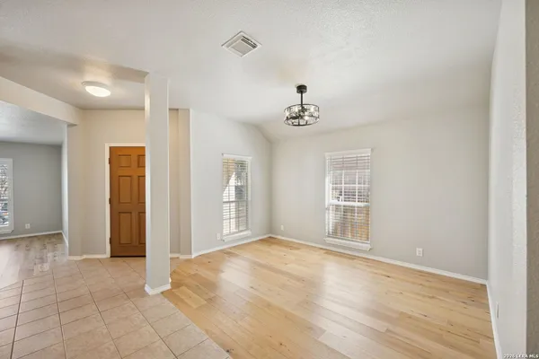 a view of a dining room with furniture and chandelier