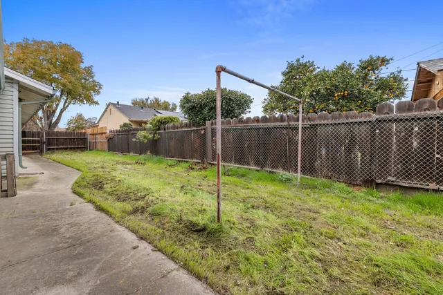 a view of a backyard with a garden and deck