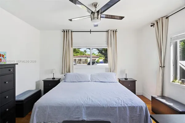 a bedroom with a bed dresser and a window