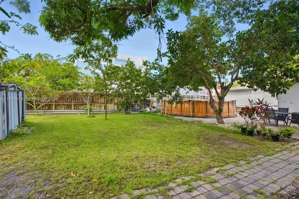 a view of a house with garden and trees