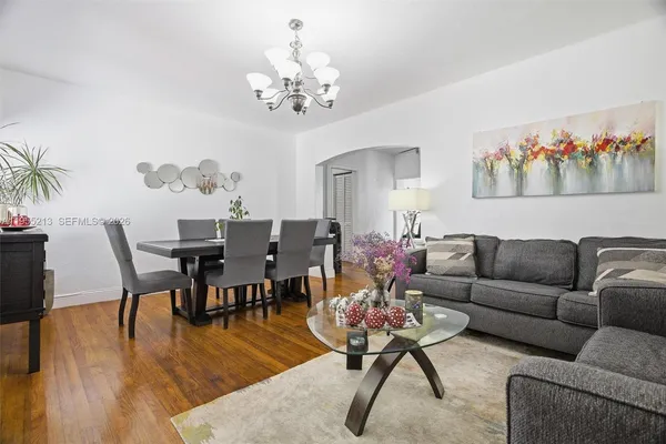 a living room with furniture and a chandelier