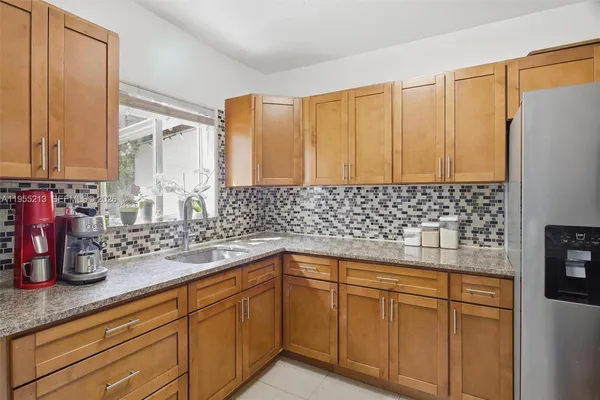 a kitchen with a sink and large window