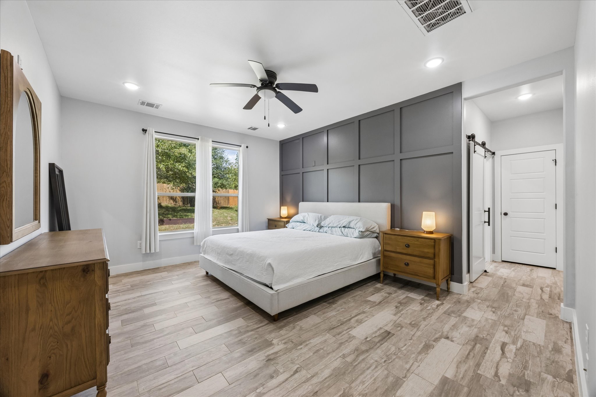 116 Mallard Road Bastrop, TX 78602 - Photo 11 of 31 Wood-look tile flooring and recessed lighting define this spacious bedroom suite.