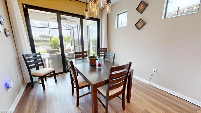 a dining room with furniture and wooden floor