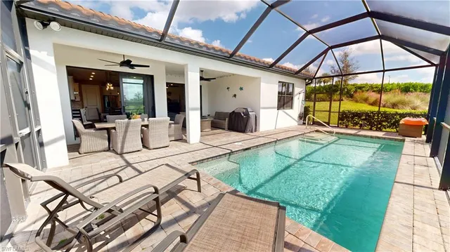 a view of a patio with table and chairs potted plants with wooden floor and floor to ceiling window