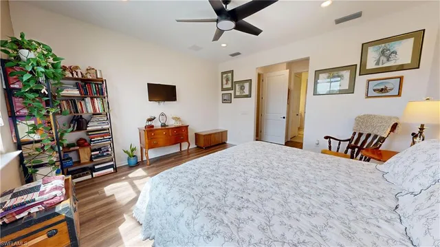 a bedroom with furniture and a book shelf