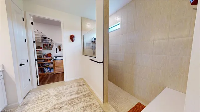 a view of a bedroom with wooden floor and closet
