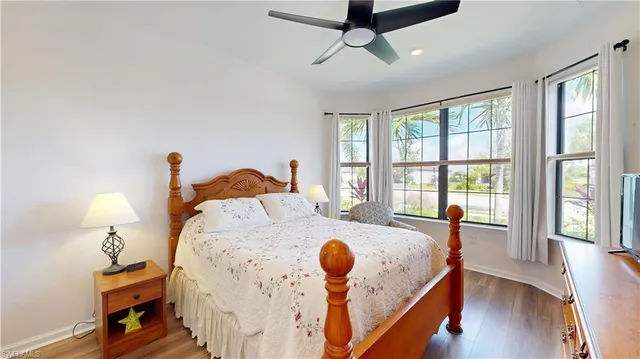 a bed sitting in a bedroom next to a window