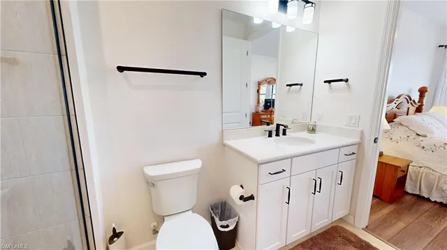 a bathroom with a sink a toilet and a mirror