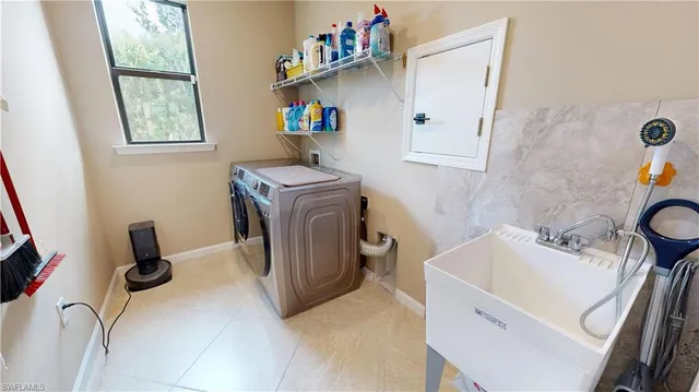 a bathroom with a sink and a washing machine